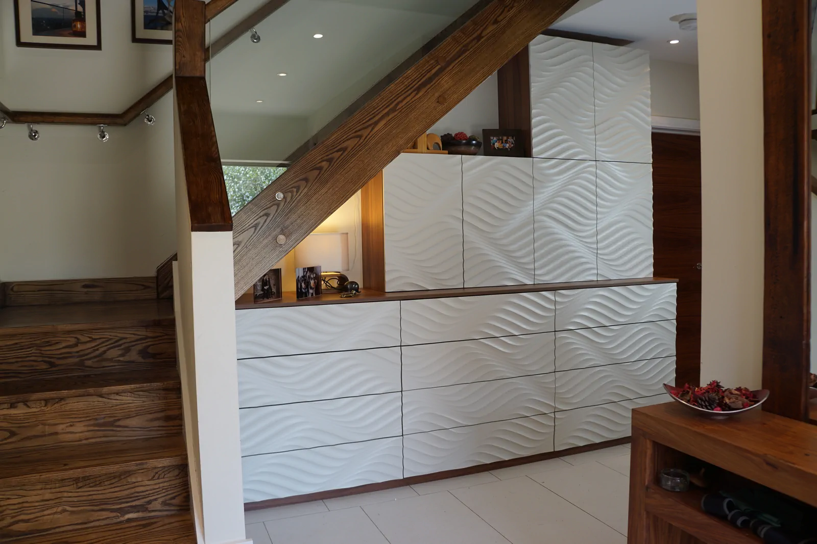 Custom media unit in Natural Dijon Walnut with sculpted Seharra Dune facia