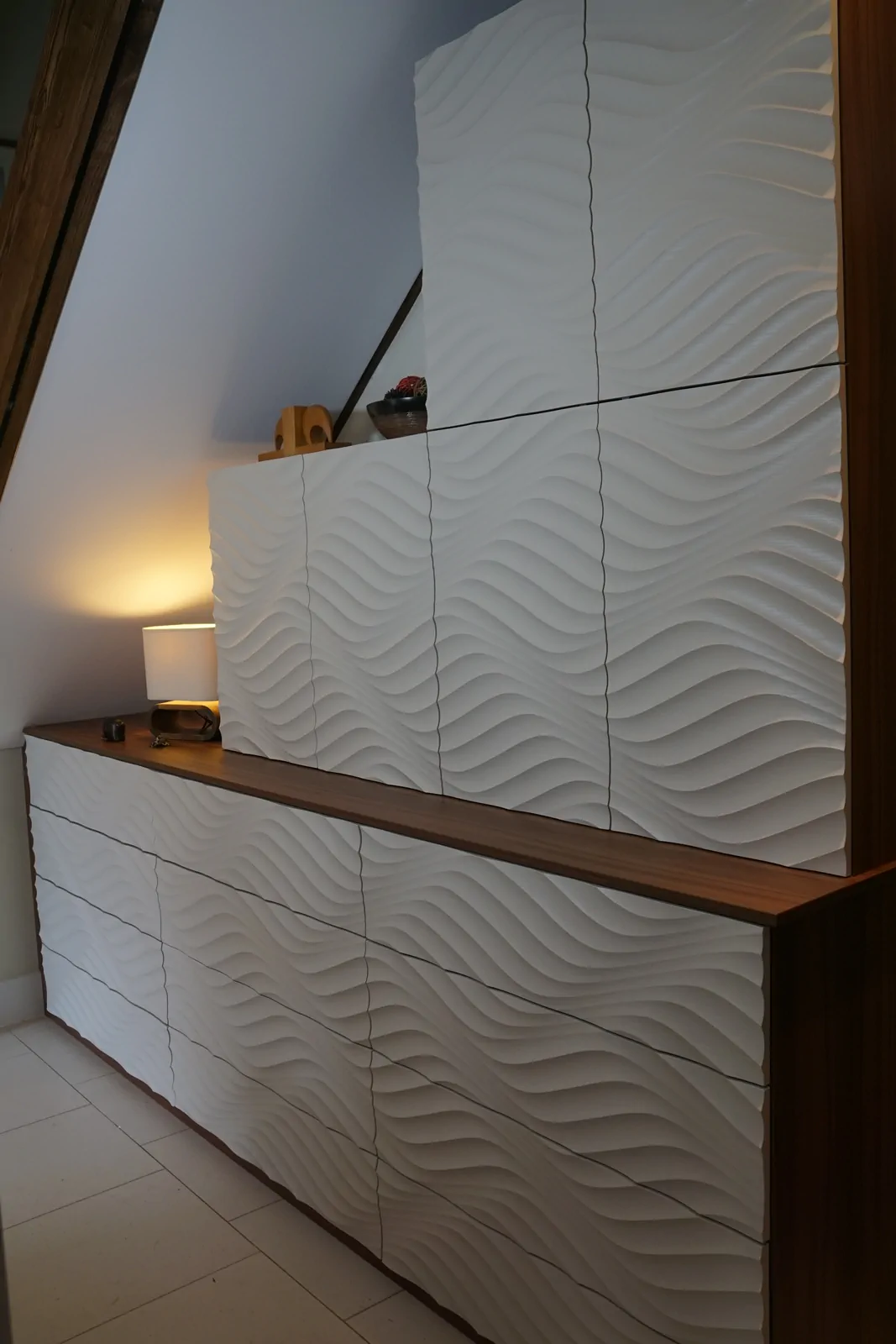 Fitted furniture under staircase showing stepped wall units and open niches
