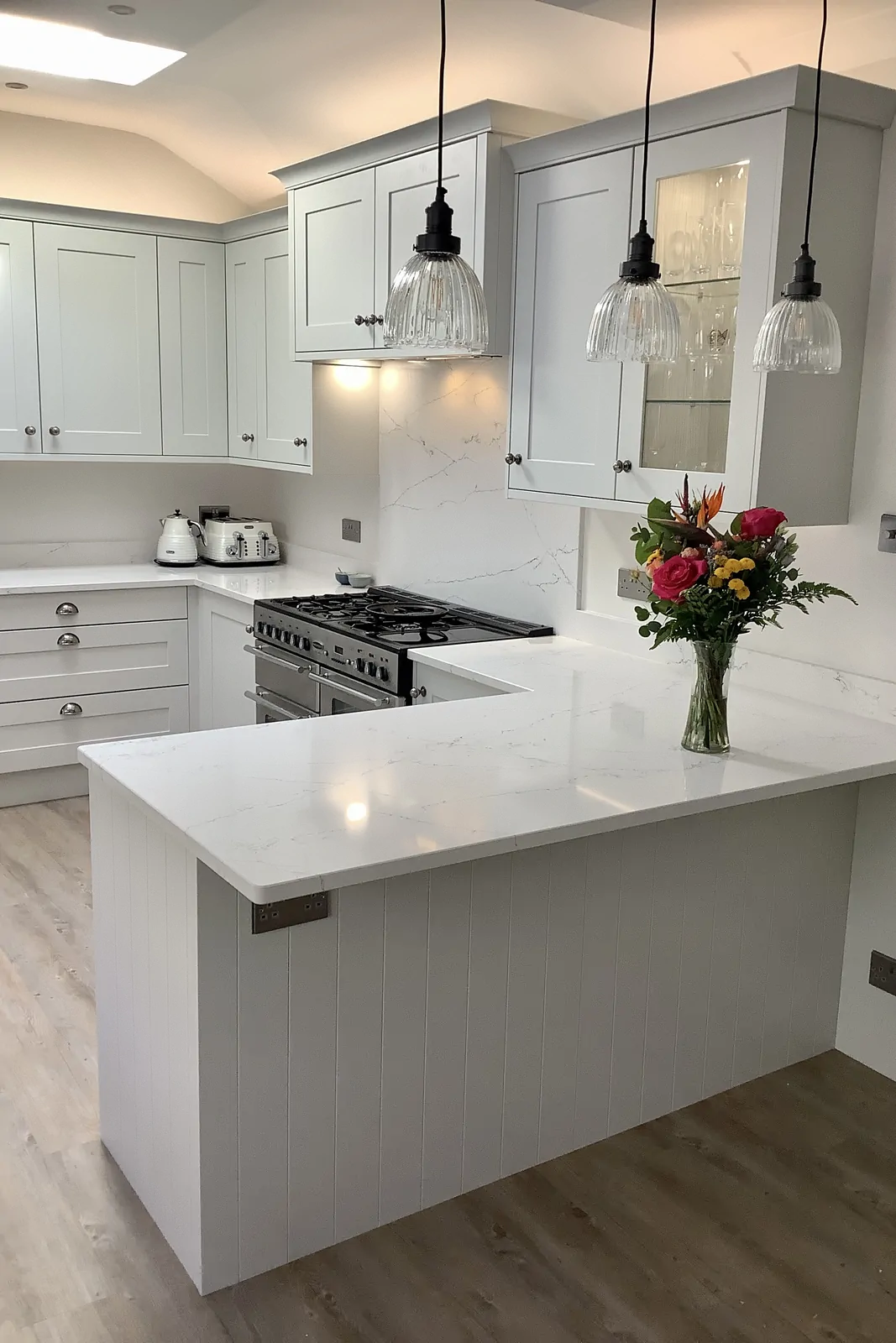 Highland Grey painted shaker kitchen with stainless-steel Rangemaster range and quartz splashback