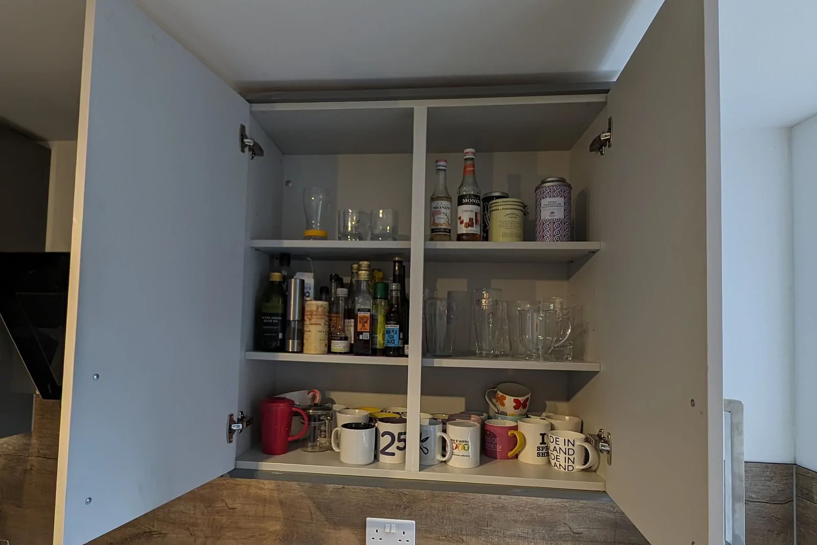 Deep wall unit with plenty of adjustable shelf storage in a modern gloss Dust Grey kitchen.
