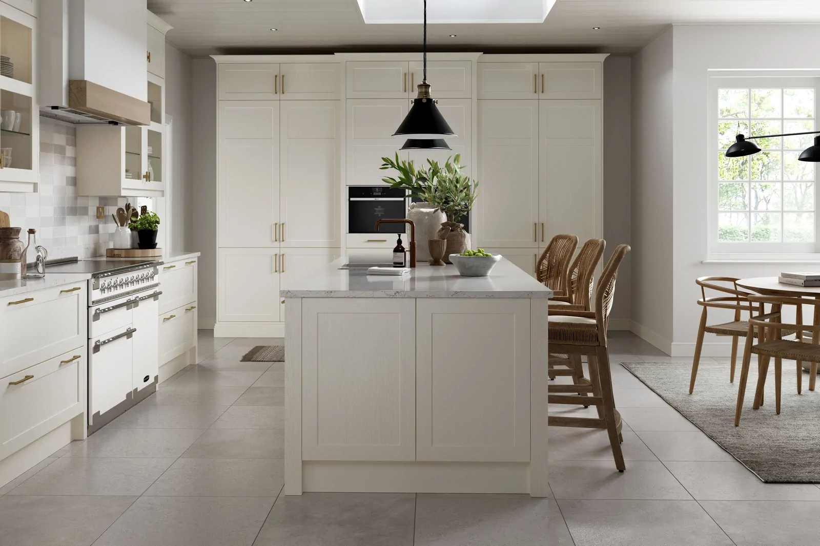 Porcelain shaker kitchen with central island, larder wall, range cooker, and dining area by a window, showing calm sight lines